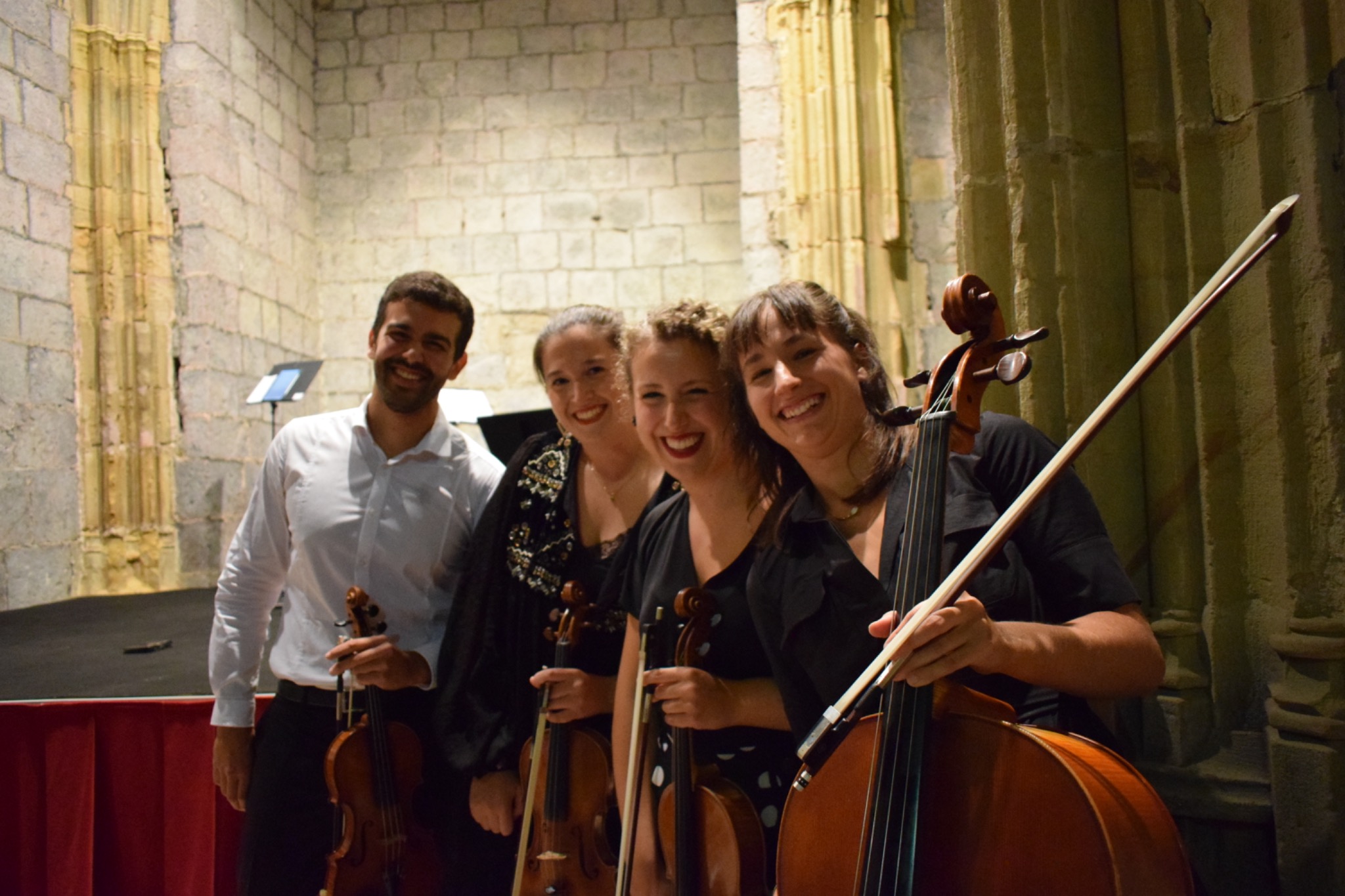 Los cuatro integrantes de Aralar Quartet con sus instrumentos en un interior de piedra