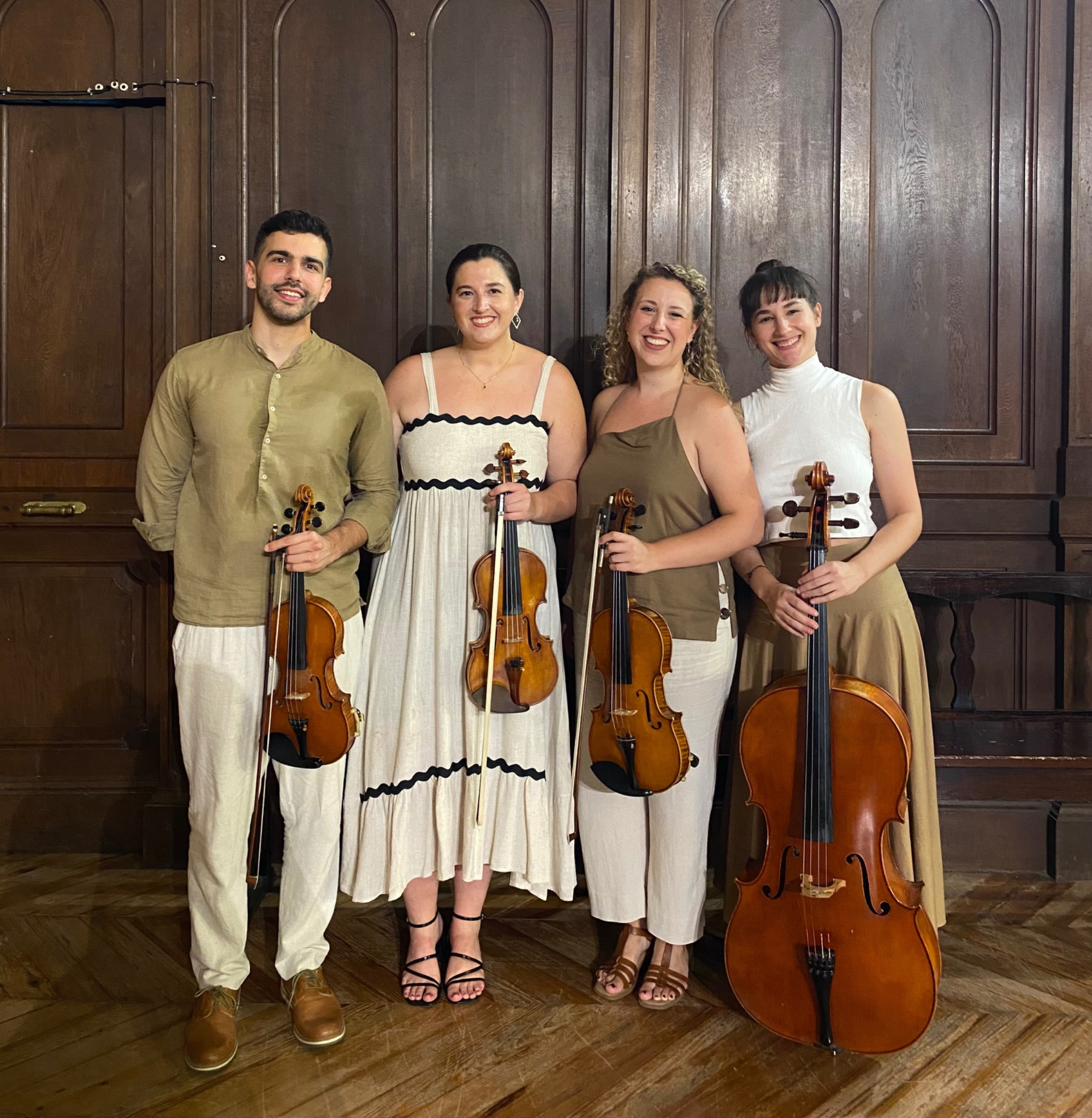 Los cuatro músicos de Aralar Quartet con sus instrumentos ante un fondo de madera